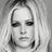 Black-and-white portrait of a person with long blonde hair, showing subtle variations in facial expression and hair positioning across four