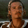 Animated sequence showing two characters with long hair, one in a brown jacket and white collar, the other with dreadlocks and earrings, transitioning from neutral expressions to open-mouthed gestures.