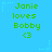 Pixelated green text on a bright blue background with small light-blue stars, displaying "Janie loves Bobby" and a heart symbol.