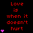 Red text on black background reads 'Love is when it doesn't hurt' with pink heart symbols in vertical
