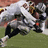 A static image with a red background featuring yellow text and a football player photo.