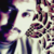 Pixelated static image of a stylized face with abstract purple and blue patterns on the left side, set against a light background with scattered dark shapes.
