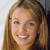 A static pixelated portrait of a person with light brown hair, fair skin, and a smiling expression against a light background.