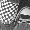 Black-and-white checkered pattern on a shoe with visible laces and a curved sole edge.