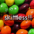 Pixelated image of colorful candy-like spheres with overlaid text reading 'skittless!!' in white block letters.