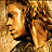 A contact sheet of three animated frames showing a character with long curly hair in warm tones, paired with text reading "TROY MAY 14TH" on a dark brown background.