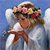 Pixelated angel figure with white wings, light brown hair, and a flower crown against a blue background, holding a star-shaped object.