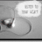 A grayscale image of a guitar with a speech bubble reading "COME TO THE LEFT" above it, next to red digital text and heart shapes.