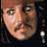 A pixelated image of a person with long dark hair and a red headband, wearing earrings, against a black background with red text reading "Wedding? I Love Weddings Drinks all around!".