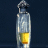 A vertical syringe with a metallic barrel, dark cap, and yellow liquid filling the lower portion against a dark blue background.