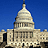 Pixelated image of a large domed building with columns against a solid blue background.