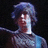 Pixelated image of a person with blue hair and light clothing against dark background, accompanied by red pixelated text blocks.