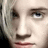 Pixelated close-up of a person's face with light skin, dark brown eyebrows, blue eyes, and pink lips, cropped to show only the upper face.