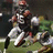 Pixelated image of a football player in action with text overlays about an injury and ambulance transport.