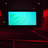 Pixelated image of a rectangular screen with cyan and green gradient display, surrounded by dark red and black circuit-like patterns on a dark background.