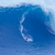 A static pixelated image of a blue wave with white foam cresting along its curved edge against a lighter blue background.