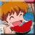 Pixelated image of a character with brown hair and closed eyes holding a red object against a multicolored background.
