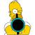 Pixelated yellow-haired character with large eyes and a dark mouth, wearing a blue-green collar and yellow shirt, holding a dark circular object.