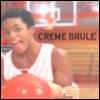 A person in a white basketball jersey holds a red basketball, with a basketball hoop and 'CREME BRULEE' text visible in the background.