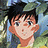 Pixelated static image of a cartoon character with spiky black hair, light skin tone, and blue eyes wearing a yellow shirt against a blurred green-and-blue background.