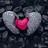 Pixelated heart icon with red center, gray wings, and dark rocky background.