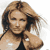 Static pixelated image of a person with light brown hair and dark roots, wearing a black strap top against a white background.