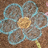 A static image shows a pixelated flower with light blue petals and a yellow center on the left, next to red background with white text reading 'olivia' on the right.