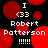 Pixelated image with red circular shapes on black background, displaying text "I <33 Robert Patterson !!!!!" in white pixel font.