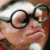 A 2x2 contact sheet of a pixelated animated icon featuring repeated text and a partial face with glasses on the top-left frame.
