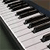 Pixelated close-up of piano keys showing black and white keys with visible pixelation and partial key edges.