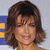 Static 50x50 pixel icon showing a woman with brown shoulder-length hair and bangs, smiling slightly against a light background with partial blue and yellow elements on the left.