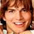 Static pixelated image of a person with light brown hair, closed eyes, and a broad smile showing teeth.