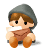Pixelated character with brown hair and gray hooded cloak, seated on white base, holding white object to mouth.