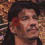 Pixelated static image of a person's face with visible facial features and partial background elements, rendered in low resolution at 45x45 pixels.