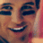 A pixelated image split into two sections: a close-up of a smiling person's face on the left and red text on a blue background on the right.