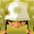 Pixelated character wearing white hard hat with circular detail, dark hair, green shirt, holding brown objects against yellow background