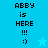 Pixelated text 'ABBY is HERE !!! :)' on cyan background with a light blue star icon, displayed in two identical