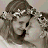 Pixelated image of a woman with braided hair wearing a white floral headband, next to text reading 'friends are sisters by choice' on a beige background.