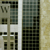 A pixelated static image shows a building facade with vertical white lines and a grid of dark windows against a light background.