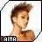 Pixelated profile of a person with spiked brown hair, light skin, and shoulder-length hair, facing right with a neutral expression.