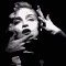 Black-and-white animation of a person with short hair making repeated hand-to-face gestures against a solid black background.