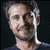 Three distinct portrait images of men displayed in a with varying backgrounds and attire