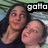 Two people in a close pose with one person's head resting on the other's shoulder, against a striped background.