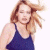 A pixelated image of a person with light brown hair wearing a dark blue sleeveless top against a white background, next to green text on a dark green background.