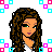 Pixelated cartoon woman with long brown hair and green eyes, wearing white top and pink checkered shorts, standing next to partial figure in black high heels.
