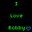 Green text on black background reads "I Love Bobby" with a blue heart symbol, arranged in a pattern with repeated elements