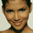 Static pixelated close-up of a person's face with dark hair and a black choker, set against a light background.