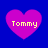 Four pink hearts on a blue background, each containing the text 'Tommy' in yellow pixelated font.
