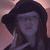 A person wearing a dark wide-brimmed hat and long hair, with hand near face in three showing slight pose variation