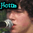 Pixelated image of a person holding a microphone with cyan text reading 'Pattie' on black background.